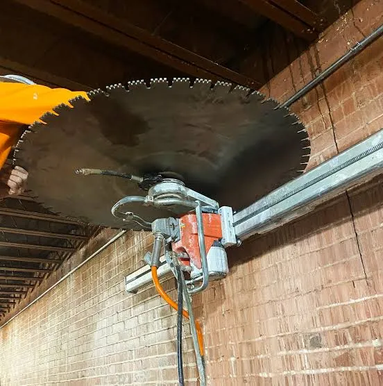 Concrete saw mounted for an overhead cut